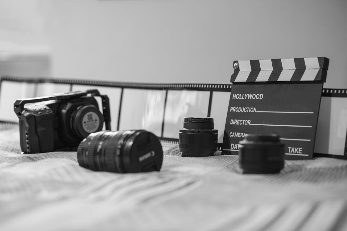 Hollywood divided as Lionsgate's AI collaboration with Runway faces ethical scrutiny 1 Free Grayscale Photo of a Clipboard Near Camera Lens Stock Photo